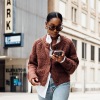 girl walking while looking at phone