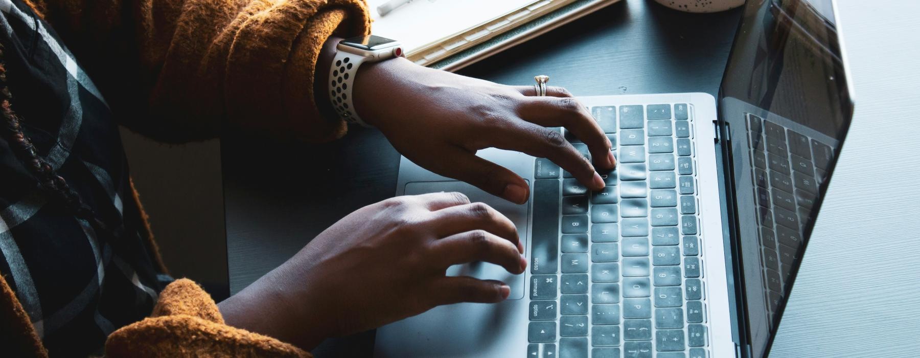 a person typing on a laptop