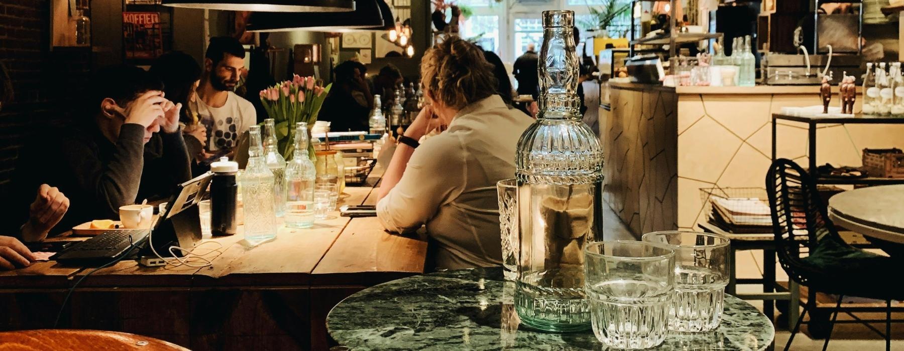 people sitting at tables in a restaurant